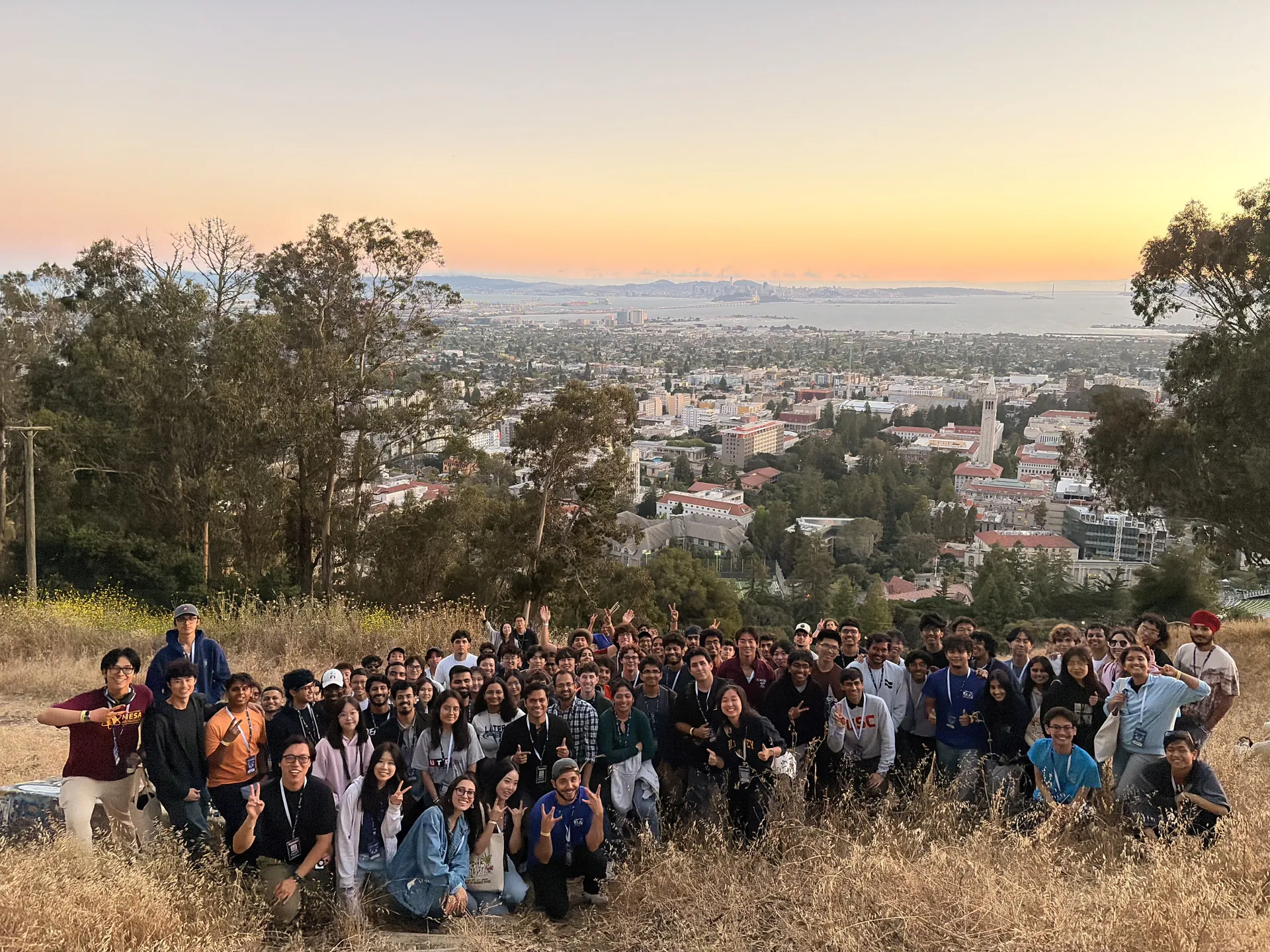 Foto grupal de participantes del UC Berkeley AI Hackathon al atardecer, con vista a Berkeley